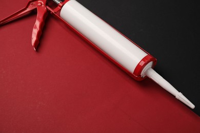 Photo of One glue gun on color background, closeup