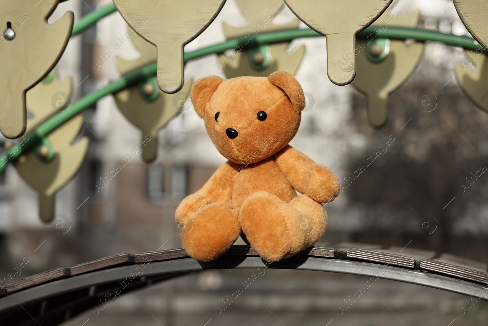 Photo of Lost brown teddy bear on playground outdoors