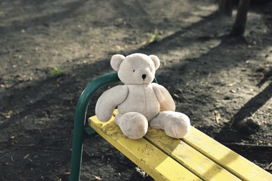 Photo of Lost white teddy bear on bench in park