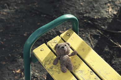 Photo of Lost knitted bear on bench outdoors, above view