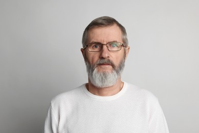 Photo of Portrait of mature man on light grey background