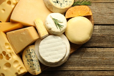 Photo of Different types of cheese on wooden table, top view