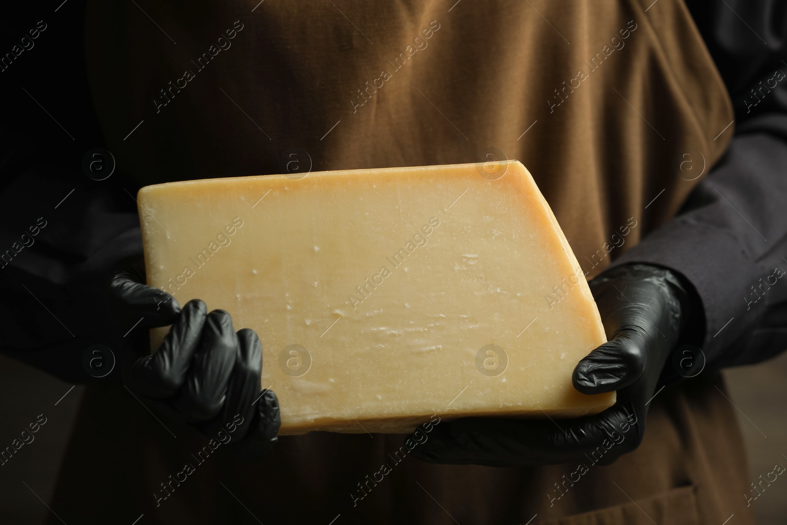 Photo of Woman with piece of delicious cheese, closeup