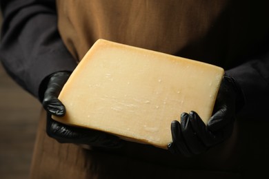 Photo of Woman with piece of delicious cheese, closeup