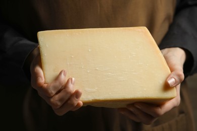 Photo of Woman with piece of delicious cheese, closeup