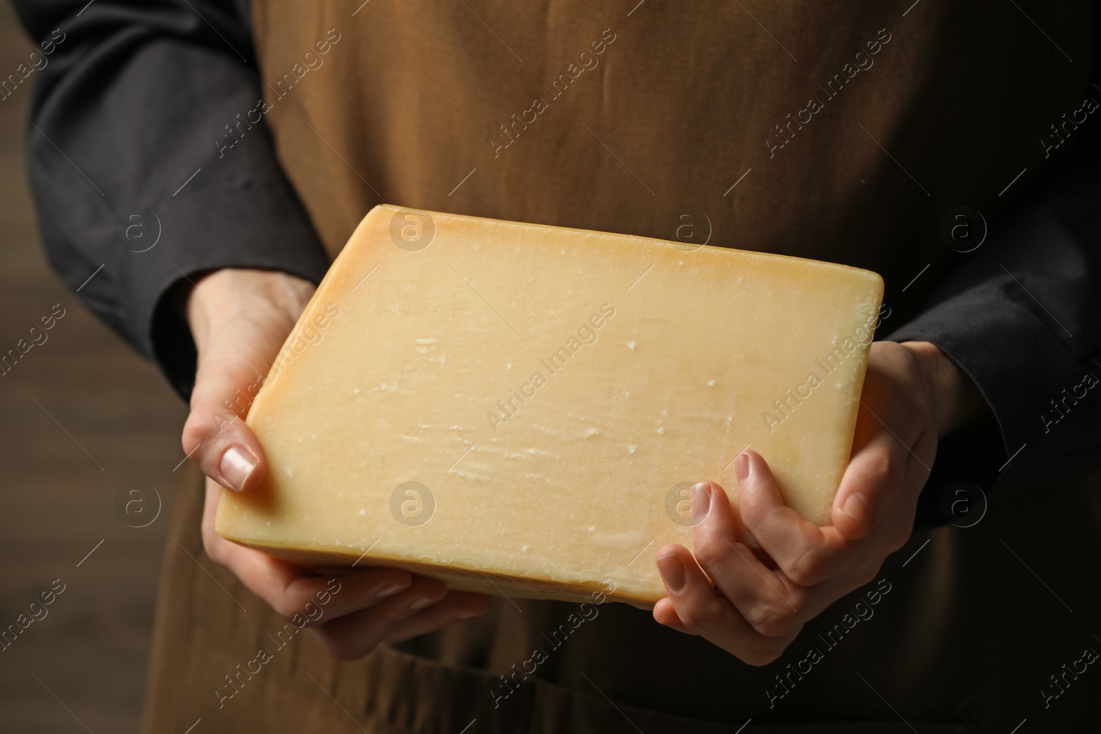 Photo of Woman with piece of delicious cheese, closeup