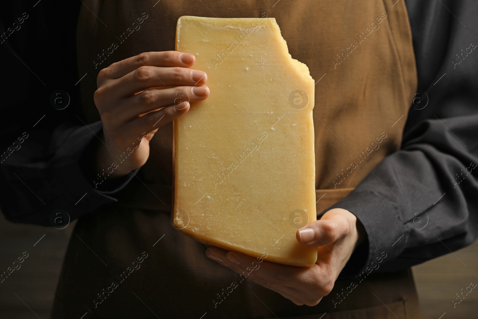 Photo of Woman with piece of delicious cheese, closeup