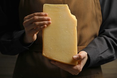 Photo of Woman with piece of delicious cheese, closeup