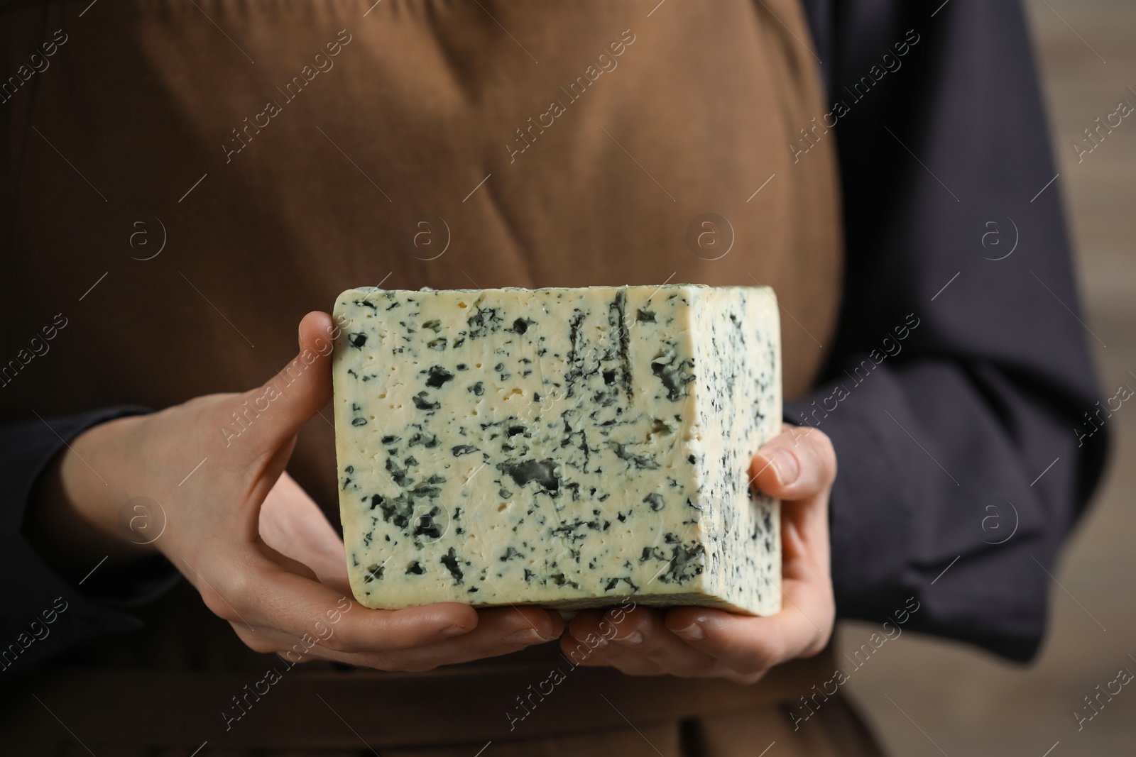 Photo of Woman with piece of delicious cheese, closeup