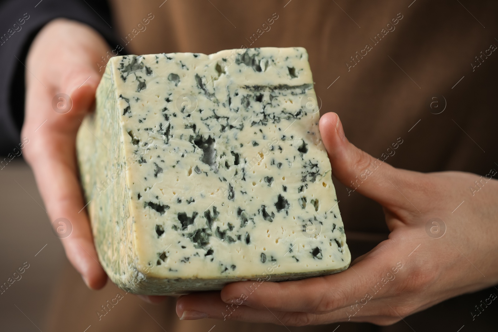 Photo of Woman with piece of delicious cheese, closeup