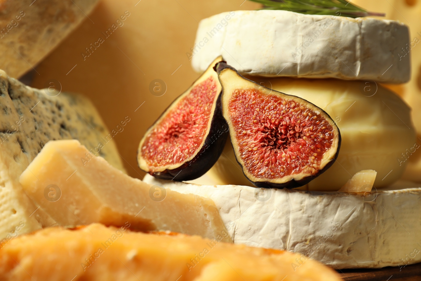 Photo of Different types of cheese and fig on table, closeup