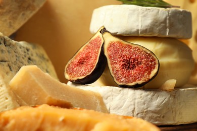 Photo of Different types of cheese and fig on table, closeup