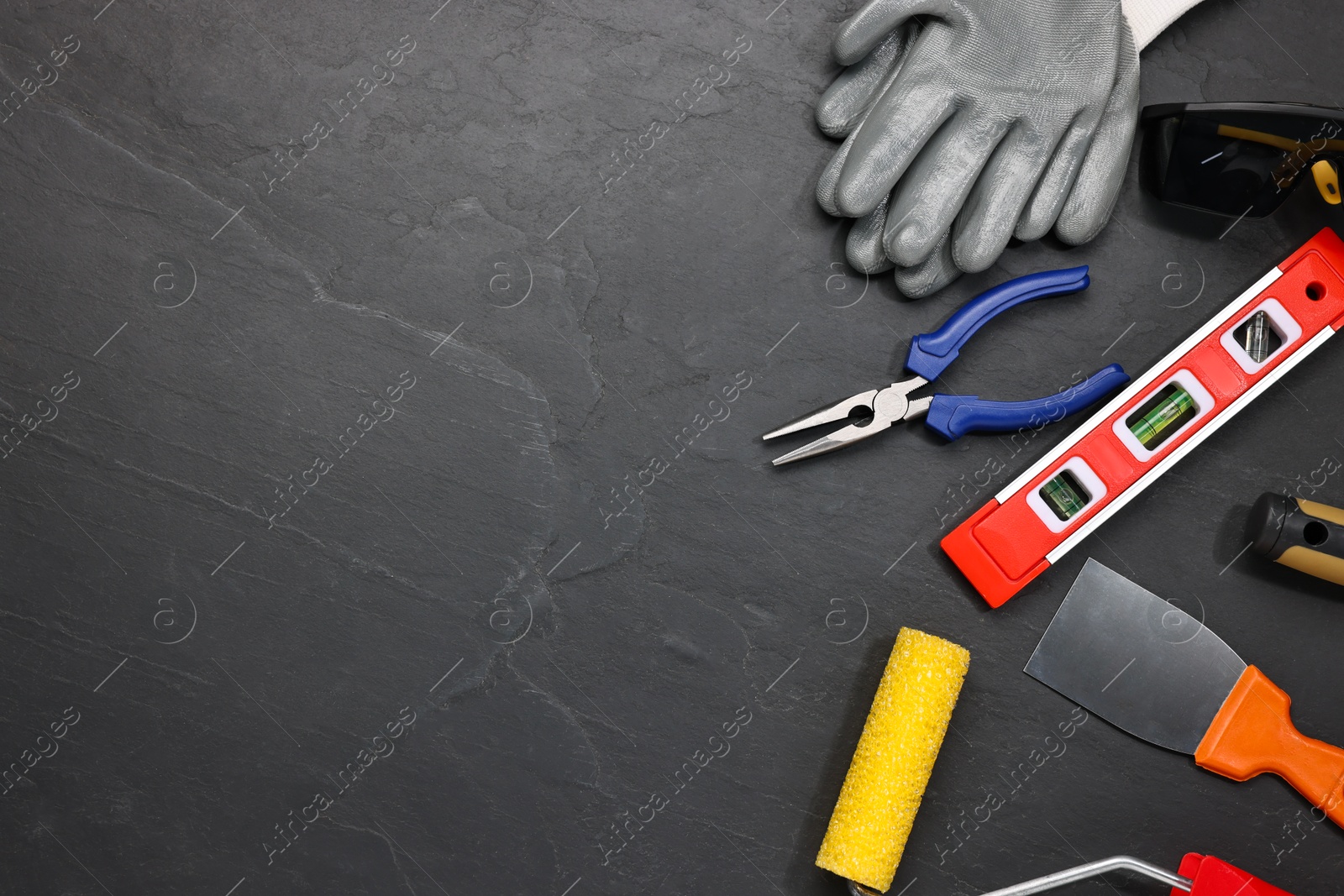 Photo of Different construction materials and tools on grey table, flat lay. Space for text