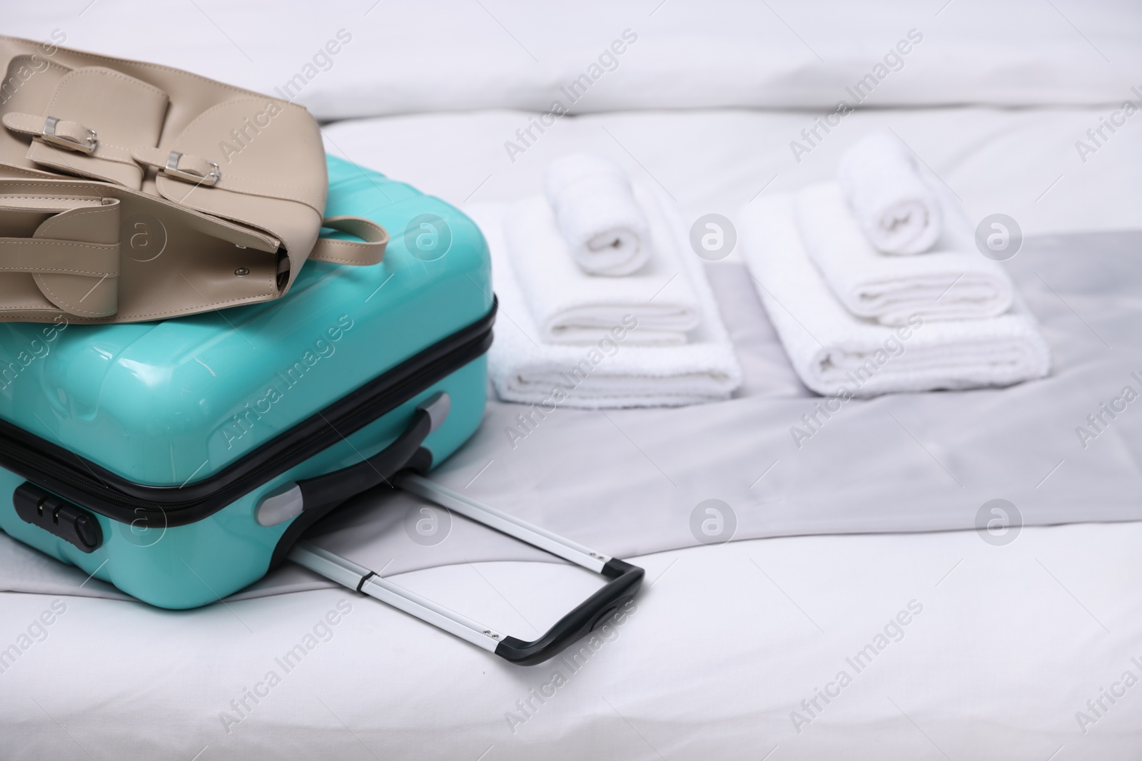 Photo of Suitcase with backpack in hotel room, closeup