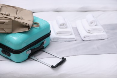 Photo of Suitcase with backpack in hotel room, closeup