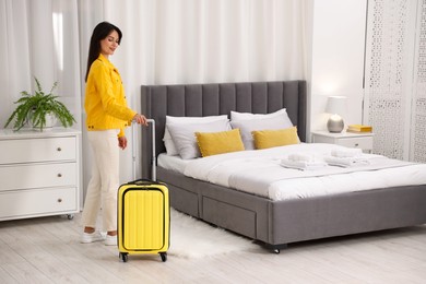 Photo of Woman with suitcase in her hotel room