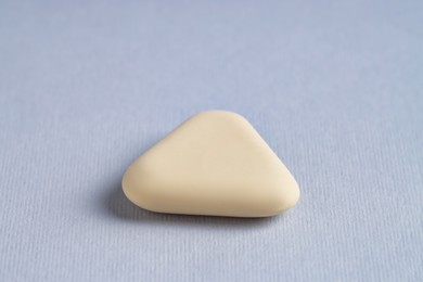 Photo of One eraser on grey background, closeup view