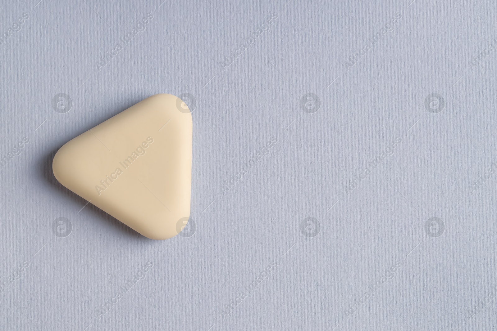 Photo of One eraser on grey background, top view. Space for text