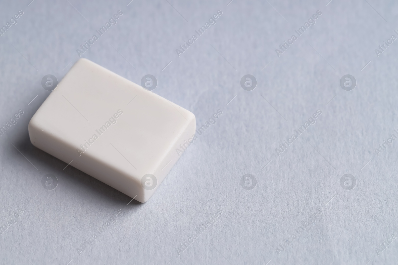 Photo of One eraser on grey background, closeup. Space for text