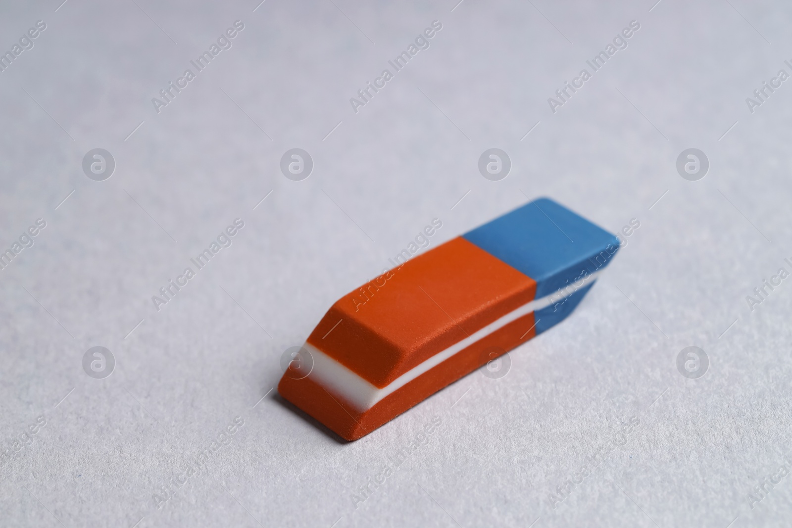 Photo of One eraser on grey background, closeup view