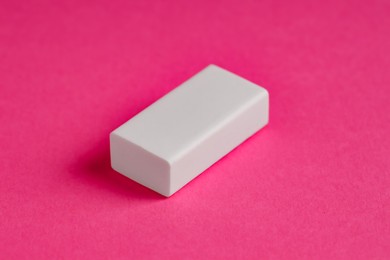 Photo of One eraser on pink background, closeup view