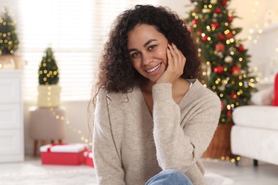 Photo of Portrait of beautiful young woman at home. Christmas celebration