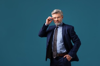 Photo of Confident banker in jacket on blue background