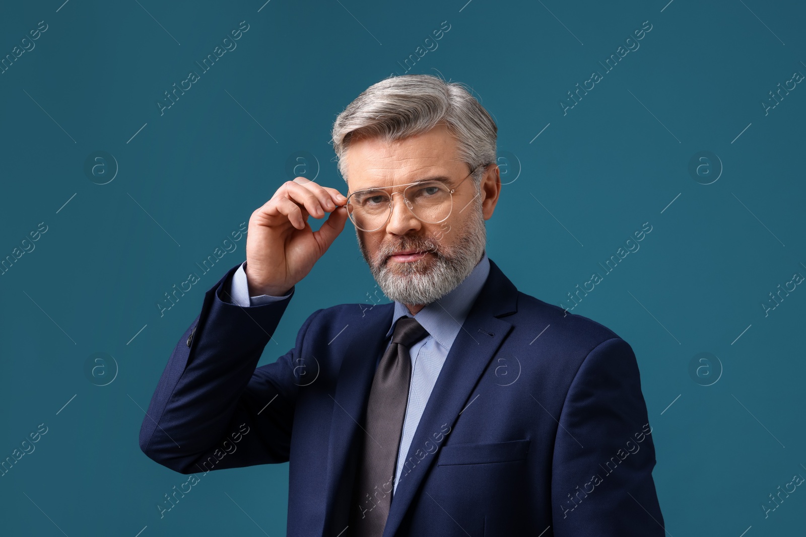 Photo of Confident banker in jacket on blue background