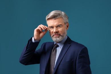 Photo of Confident banker in jacket on blue background