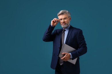 Photo of Banker with laptop on blue background, space for text