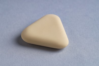 Photo of One eraser on grey background, closeup view