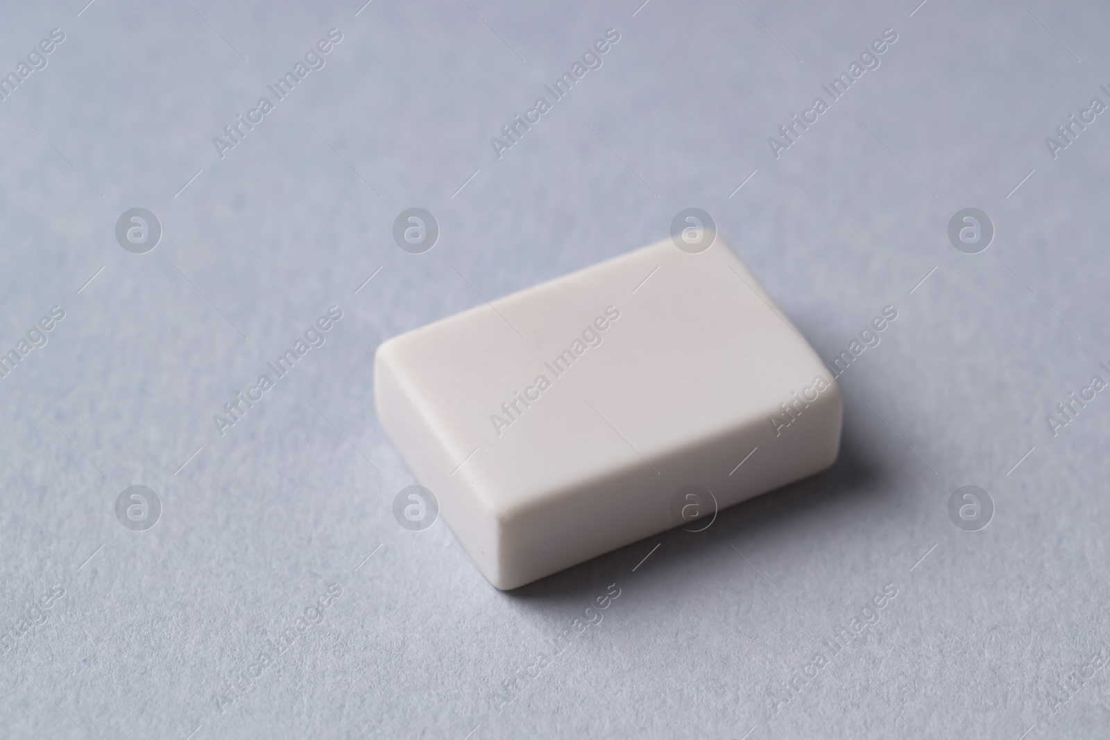 Photo of One eraser on grey background, closeup view