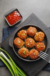 Photo of Tasty meatballs served on grey table, flat lay