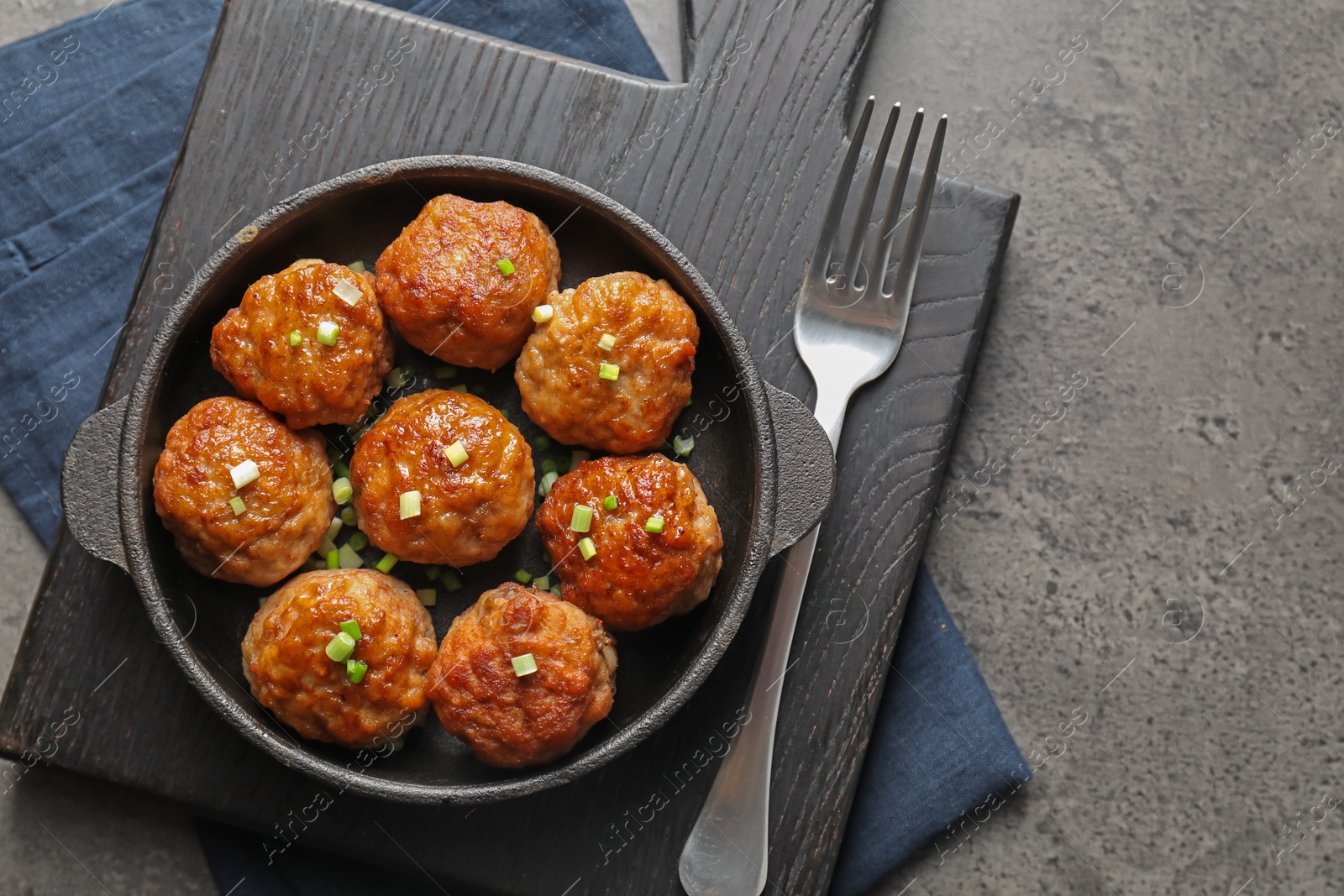 Photo of Tasty meatballs served on grey table, flat lay