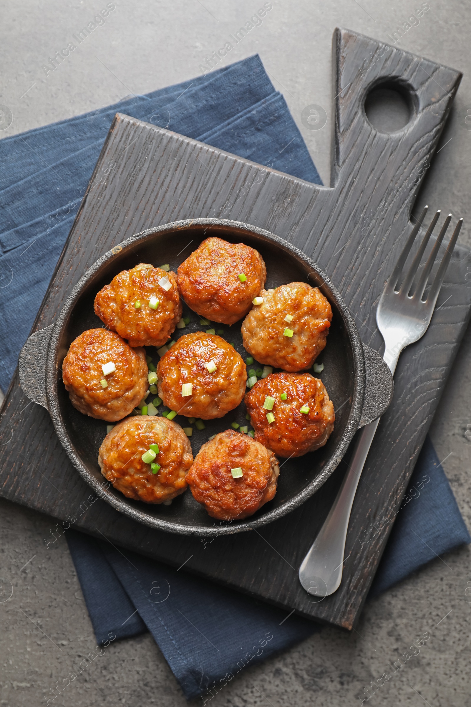 Photo of Tasty meatballs served on grey table, flat lay