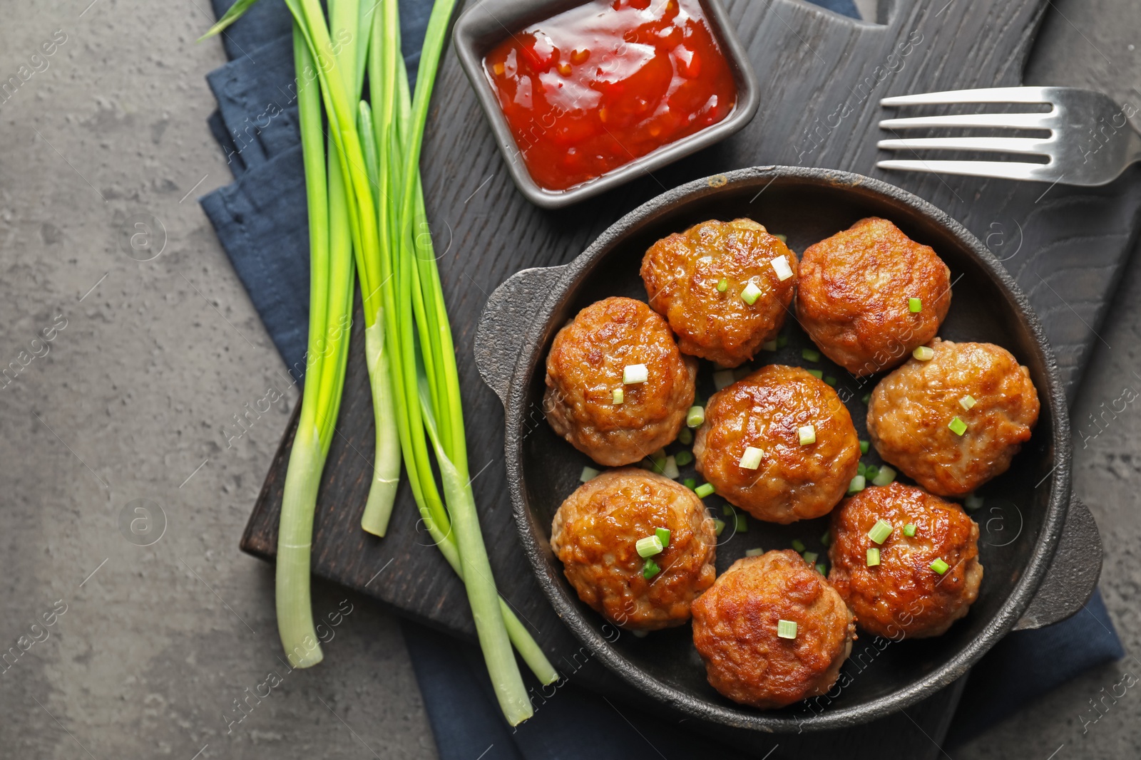 Photo of Tasty meatballs served on grey table, flat lay