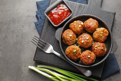 Photo of Tasty meatballs served on grey table, flat lay