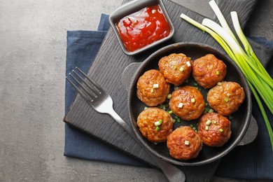 Photo of Tasty meatballs served on grey table, flat lay