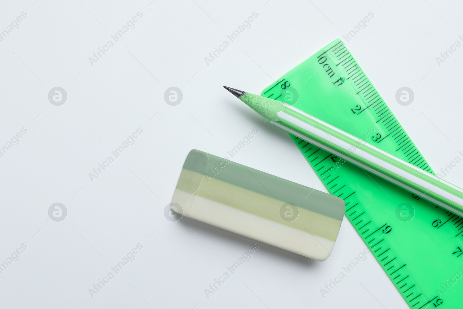 Photo of Eraser, pencil and ruler on white background, flat lay. Space for text