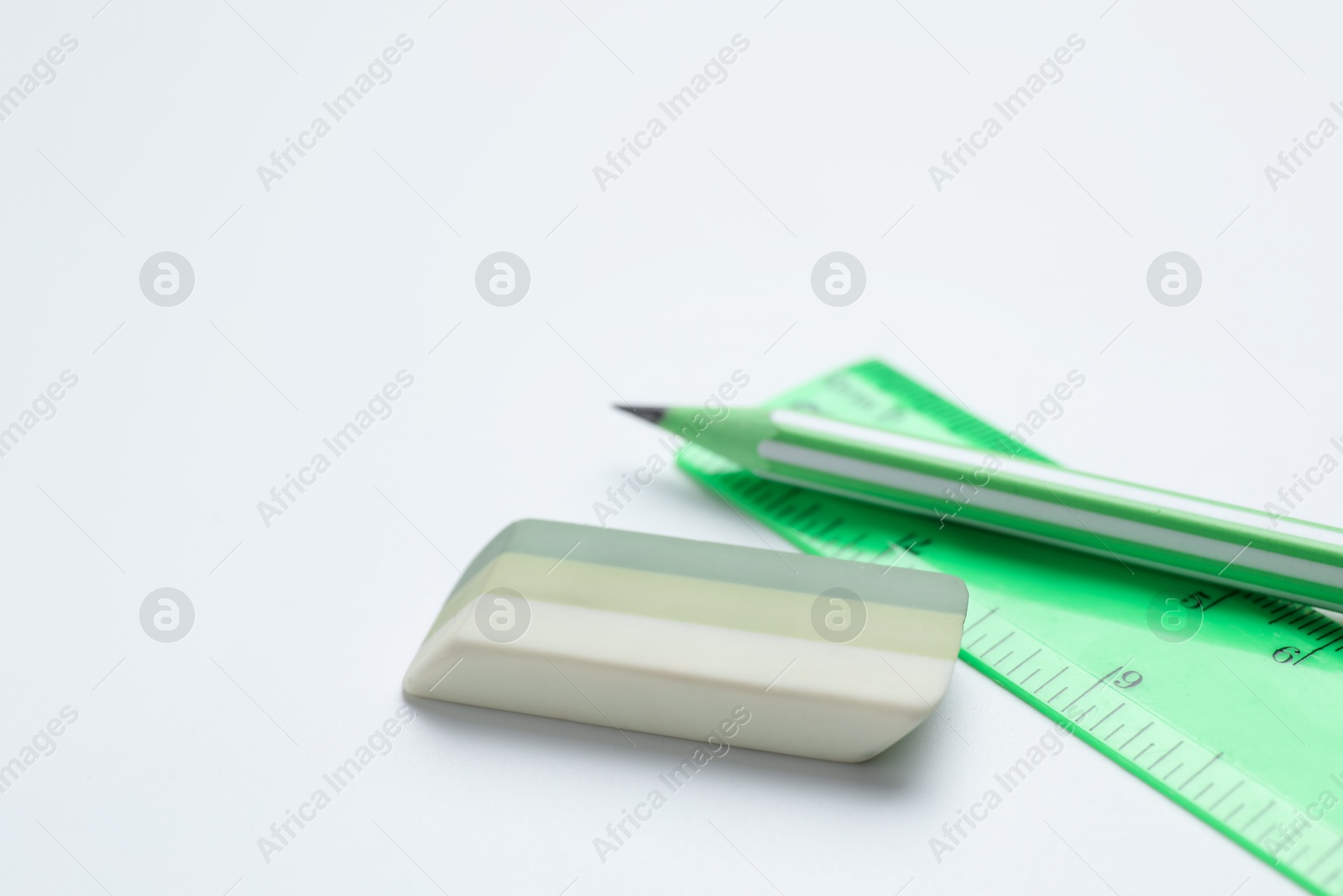 Photo of Eraser, pencil and ruler on white background, closeup. Space for text