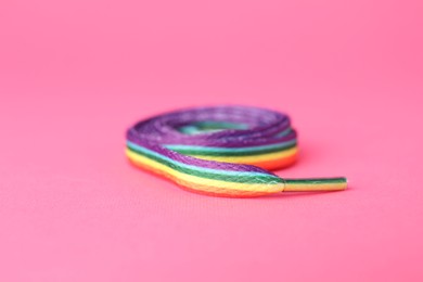 Photo of Shoelace in LGBT colors on pink background, closeup