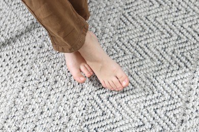 Little boy on soft carpet indoors, above view. Space for text