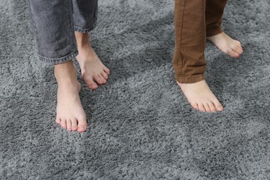 Photo of Kids on soft grey carpet indoors, closeup