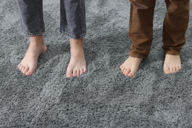 Photo of Kids on soft grey carpet indoors, closeup