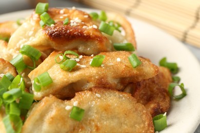 Photo of Tasty fried gyoza (dumplings) on table, closeup