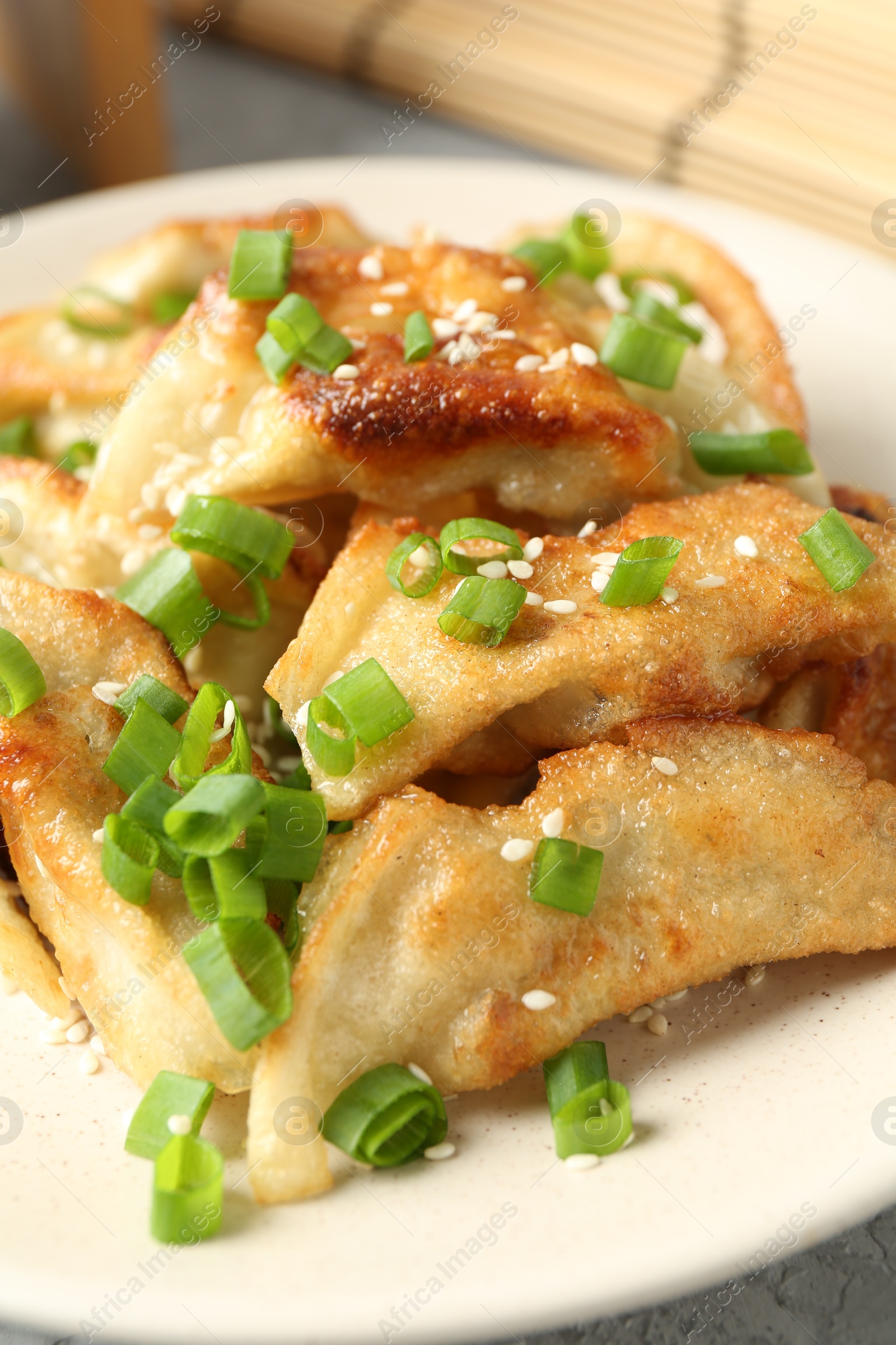 Photo of Tasty fried gyoza (dumplings) on table, closeup