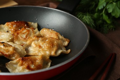 Photo of Tasty fried gyoza (dumplings) on table, closeup