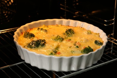 Photo of Delicious vegetable casserole in oven, closeup view