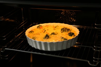 Photo of Baking dish with delicious vegetable casserole in oven