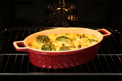 Photo of Delicious vegetable casserole in oven, closeup view